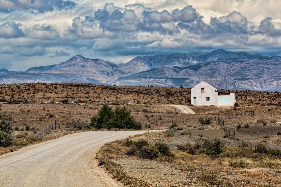 Free Image of House in the Middle of a Dirt Road 