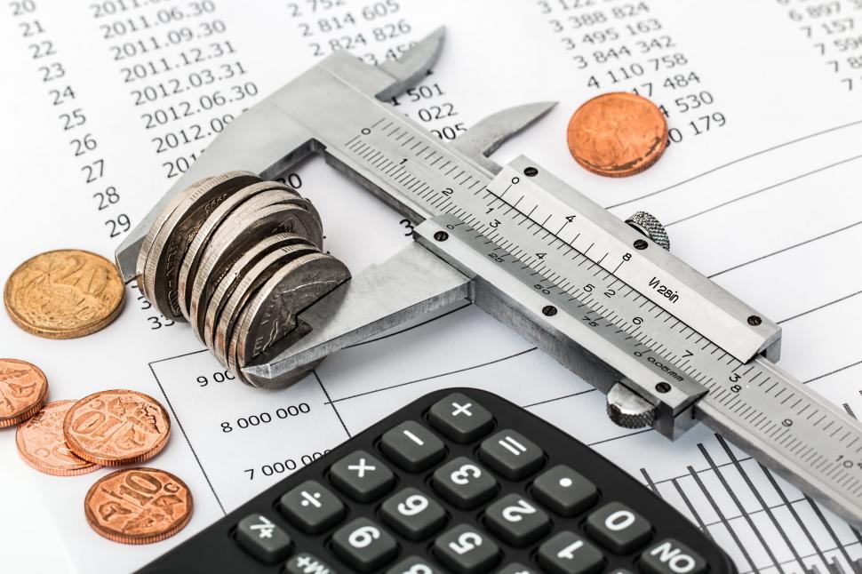 Free Image of savings budget investment money finance business financial cash income economy tax planning calculator save currency wealth accounting calculate expenses banking cost stress debt stressed crisis squeeze clamp down tight vernier coins 