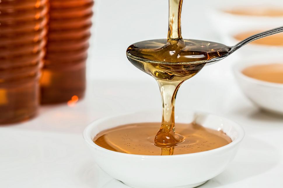 Free Image of Pouring Spoonful of Honey Into Bowl 