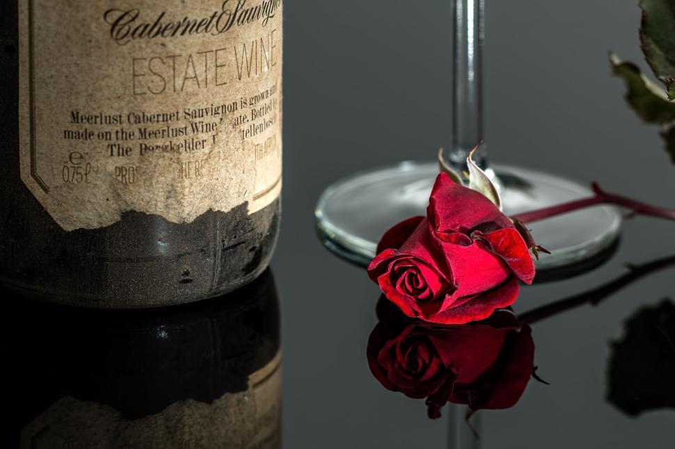 Free Image of rose wine red romantic bottle drink glass vintage red rose wineglass alcohol beverage cabernet sauvignon wine bottle wine glass valentine's day romance affair 
