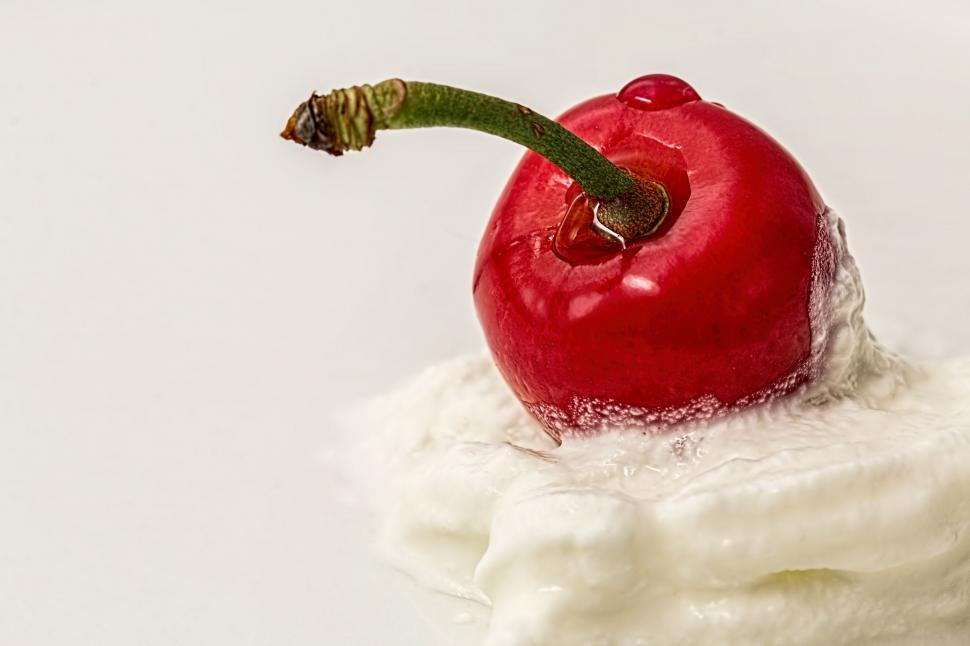 Free Image of A Slice of Cake With a Cherry on Top 