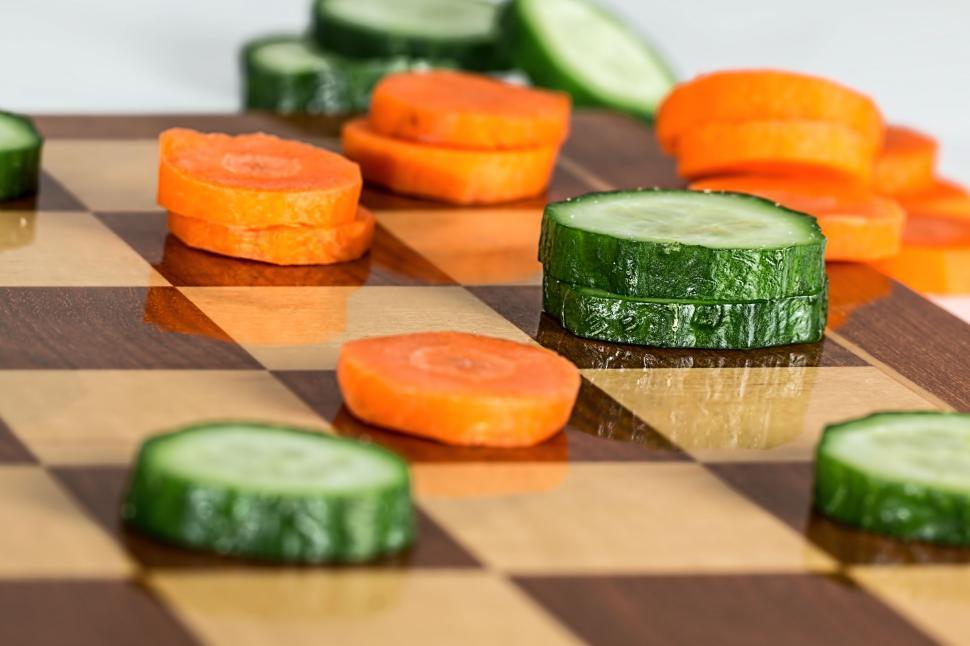 Free Image of Close Up of a Chess Board With Cucumbers and Carrots 