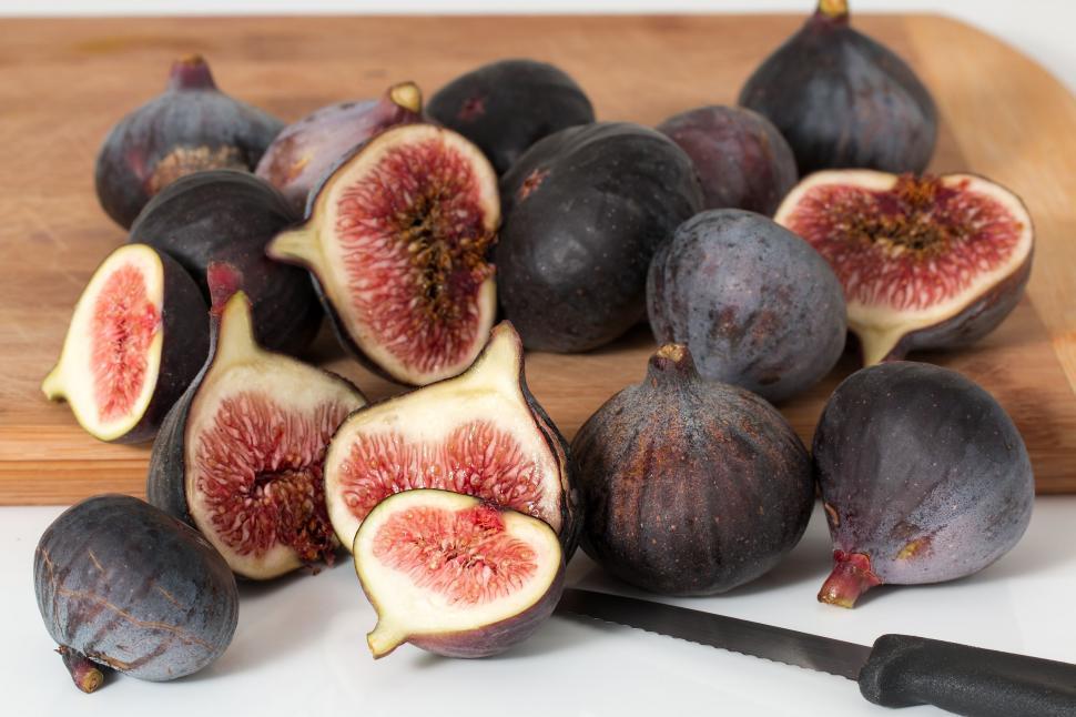 Free Image of Halved Figs on Cutting Board With Knife 