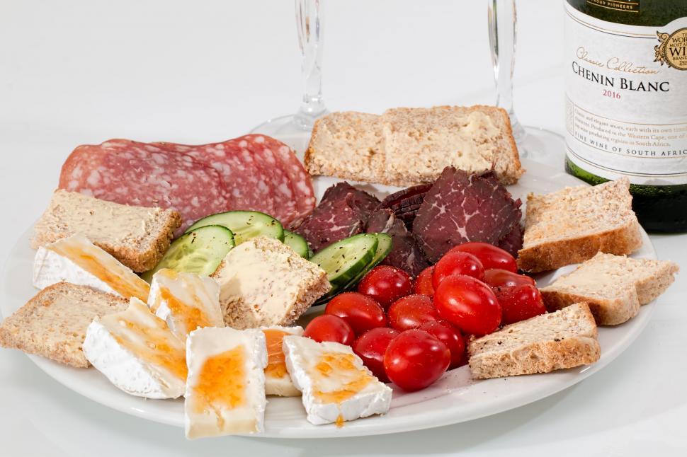 Free Image of Plate of Food and Bottle of Wine on Table 