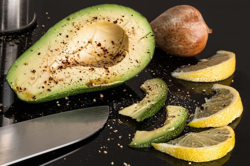 Free Image of Avocado Being Cut in Half With a Knife 
