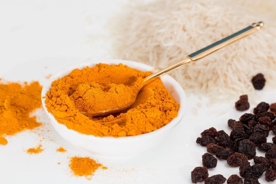 Free Image of turmeric spice curry seasoning ingredient powder cooking cuisine indian food flavor gourmet yellow rice raisins delicious tasty color eating eat colorful flavoring diet nutrition spoon basmati meal herb coloring 