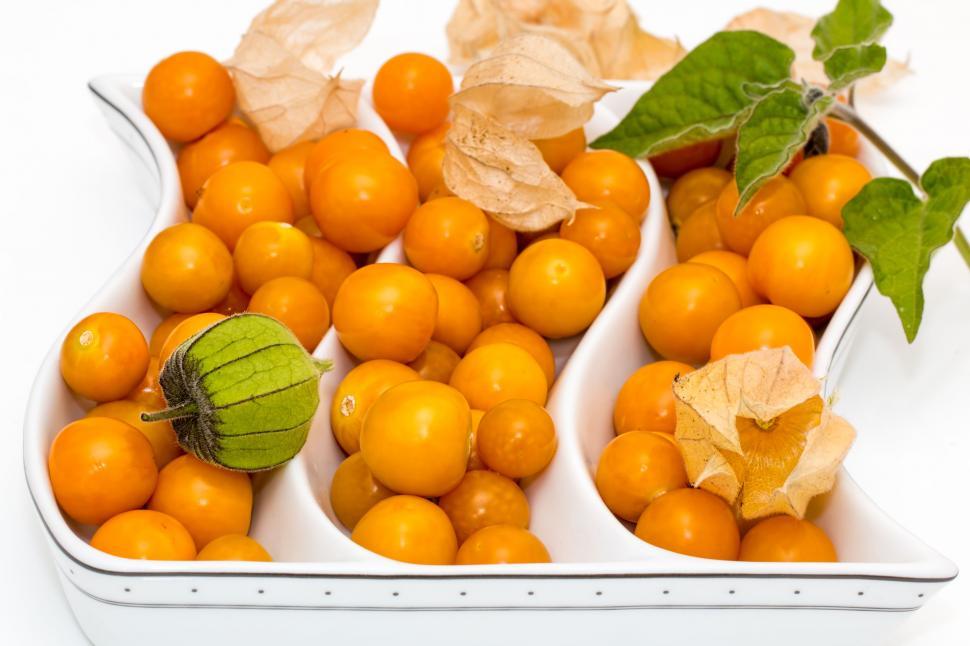 Free Image of White Dish Filled With Oranges and Green Leaf 
