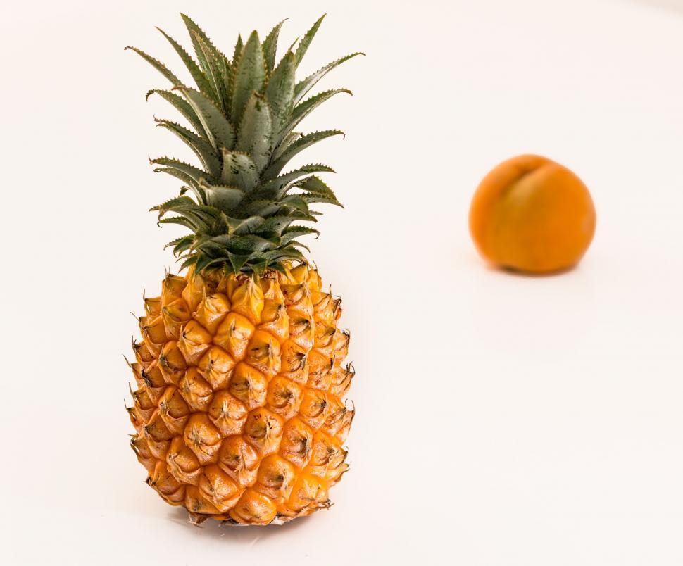 Free Image of Pineapple and Orange on White Surface 