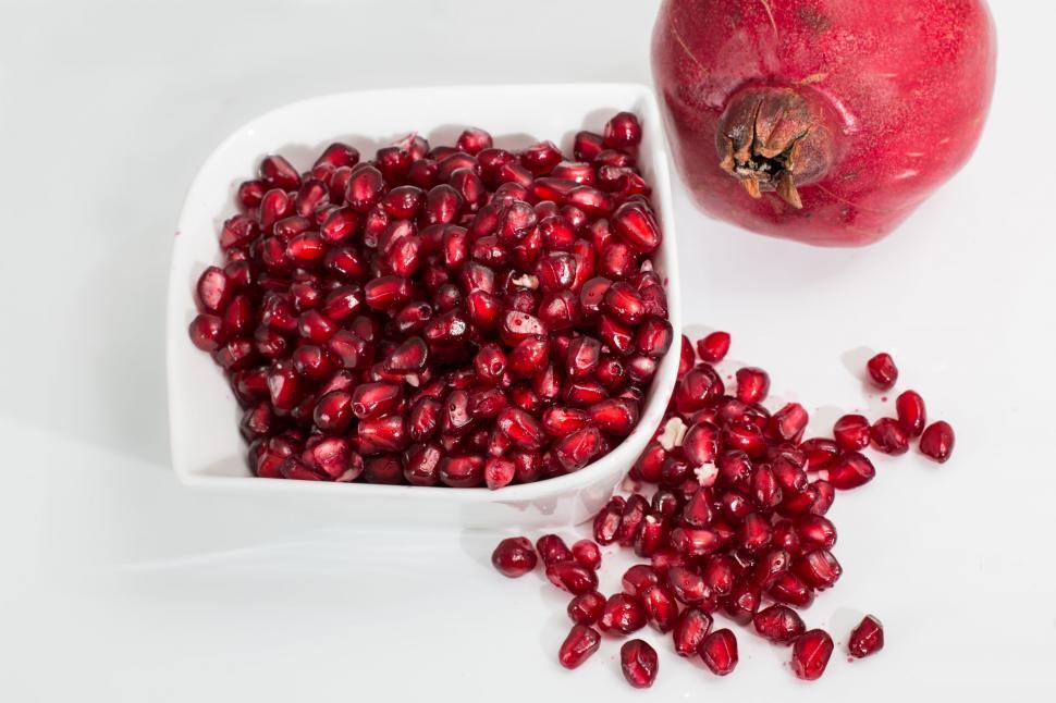 Free Image of Pomegranate Bowl and Whole Pomegranate 