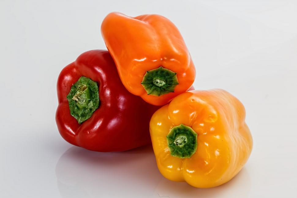 Free Image of Two Peppers on White Table 
