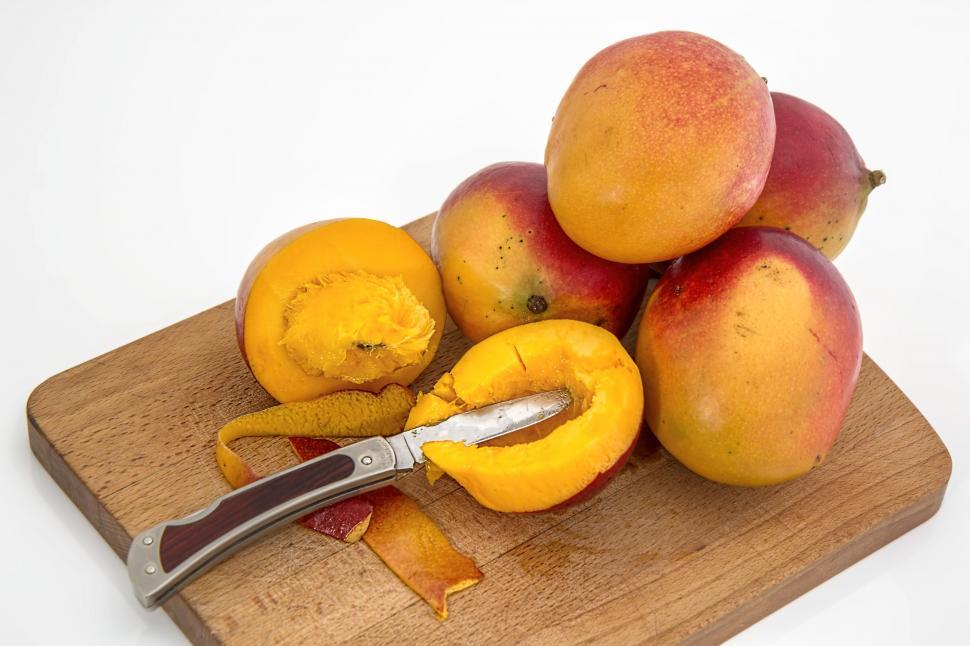Free Image of Wooden Cutting Board With Mangoes and Knife 