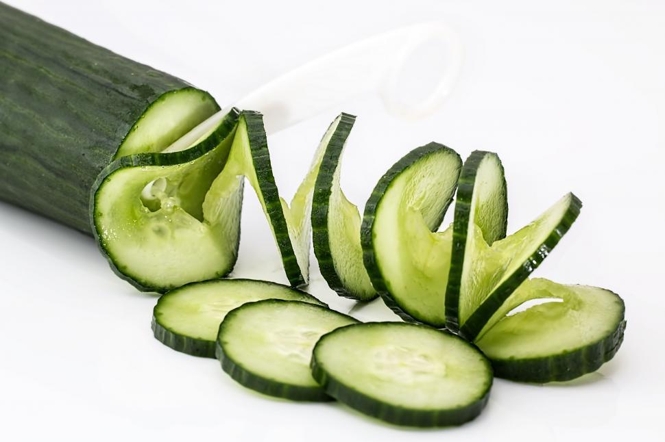 Free Image of Sliced Cucumber Slices on a White Surface 