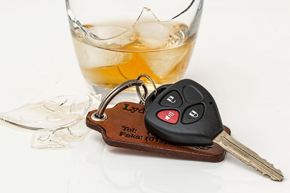 Free Image of Glass of Whiskey and Two Car Keys on Table 