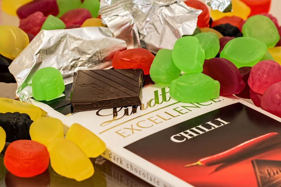 Free Image of A Pile of Candy and a Book on a Table 