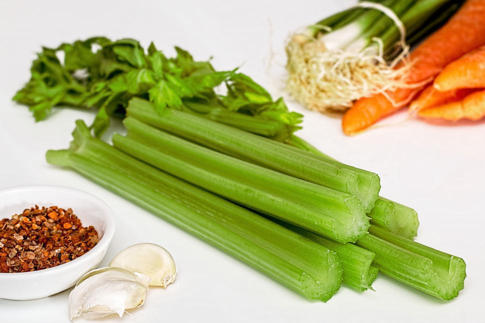 Free Image of Fresh Celery, Carrots, and Garlic on White Surface 