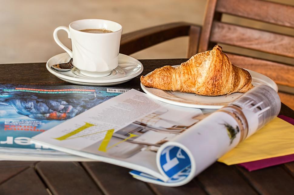 Free Image of magazine coffee break cup media read style relax leisure periodical table cafe communication lifestyle croissant reading information inform learning literature news publishing knowledge education print media page social marketing trend 