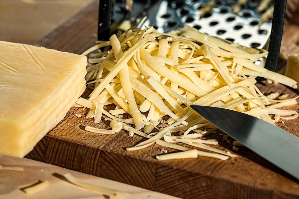Free Image of grated cheese grater cheese dairy product kitchen ingredient food protein cooking food preparation nutrition diet eating mealtime vegetarian eat saturated fat calcium healthy meal snack 
