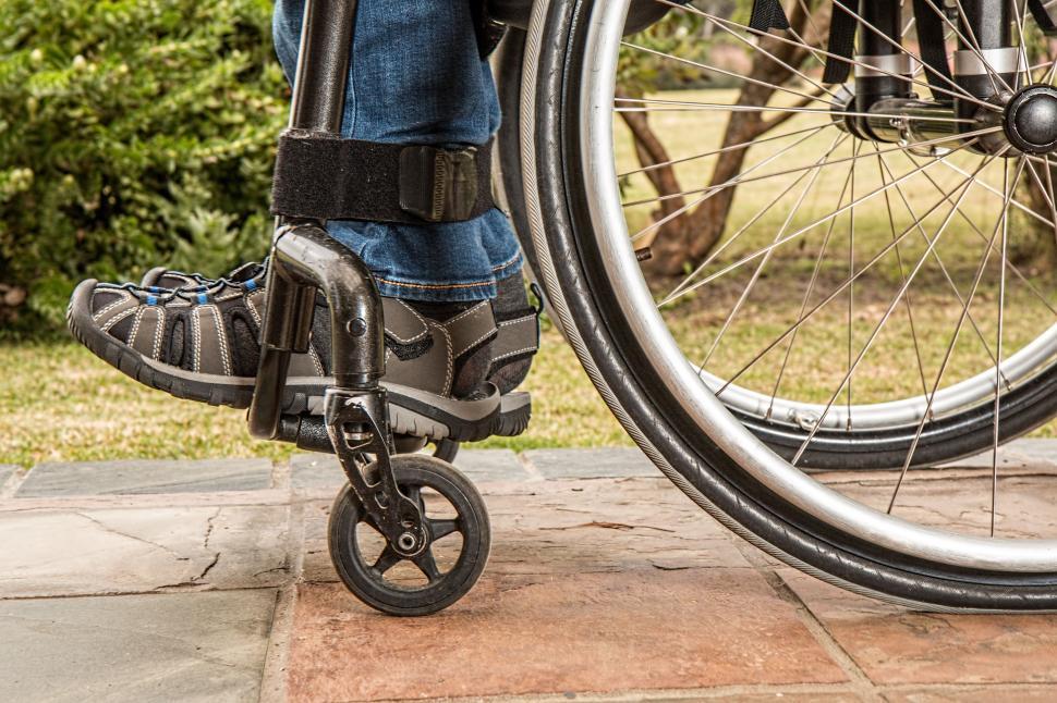 Free Image of Person in Wheelchair on Sidewalk 