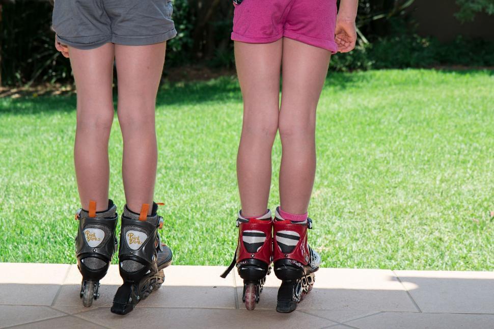 Free Image of kids roller blades skating activities summer fun child active exercise health sport legs twins fit body young activity girls fitness slim fitness girl active lifestyle play shorts footwear sports shoes 