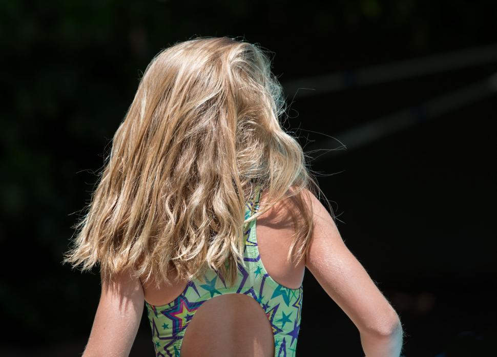 Free Image of blonde hair swimming costume girl summer young blond vacation hair care healthy sunny holiday natural wellness curly hairstyle fit swimmer hair wavy shampoo conditioner hairdresser 