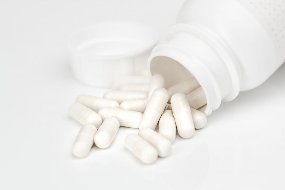 Free Image of Bottle Filled With White Pills on Table 