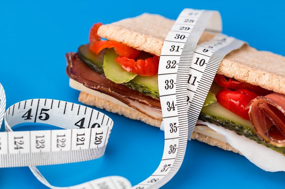 Free Image of Close Up of Sandwich Being Measured With a Tape Measure 