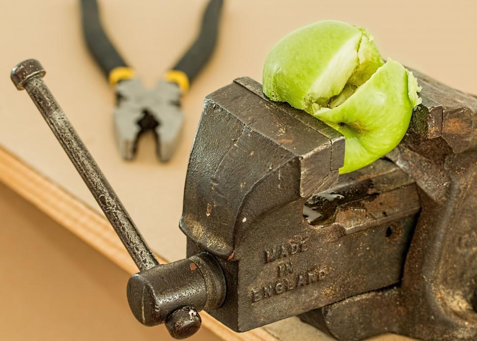 Free Image of Pair of Pliers and Green Apple on Machine 