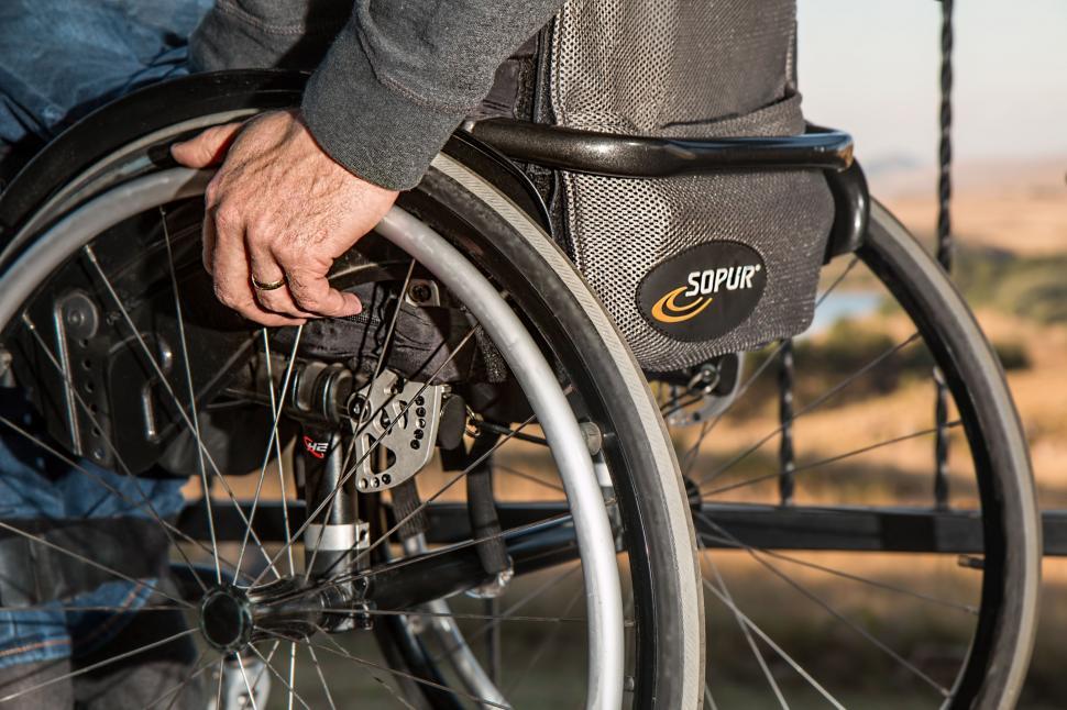 Free Image of Man in a Wheelchair Holding the Wheel 