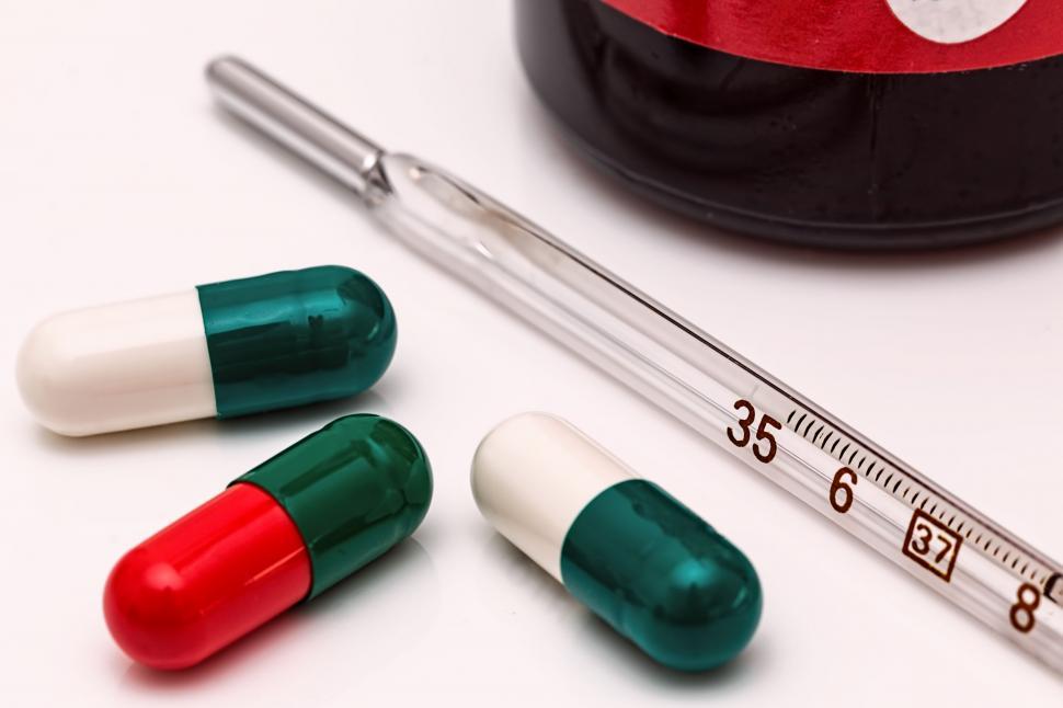 Free Image of Three Pills and a Thermometer on a Table 