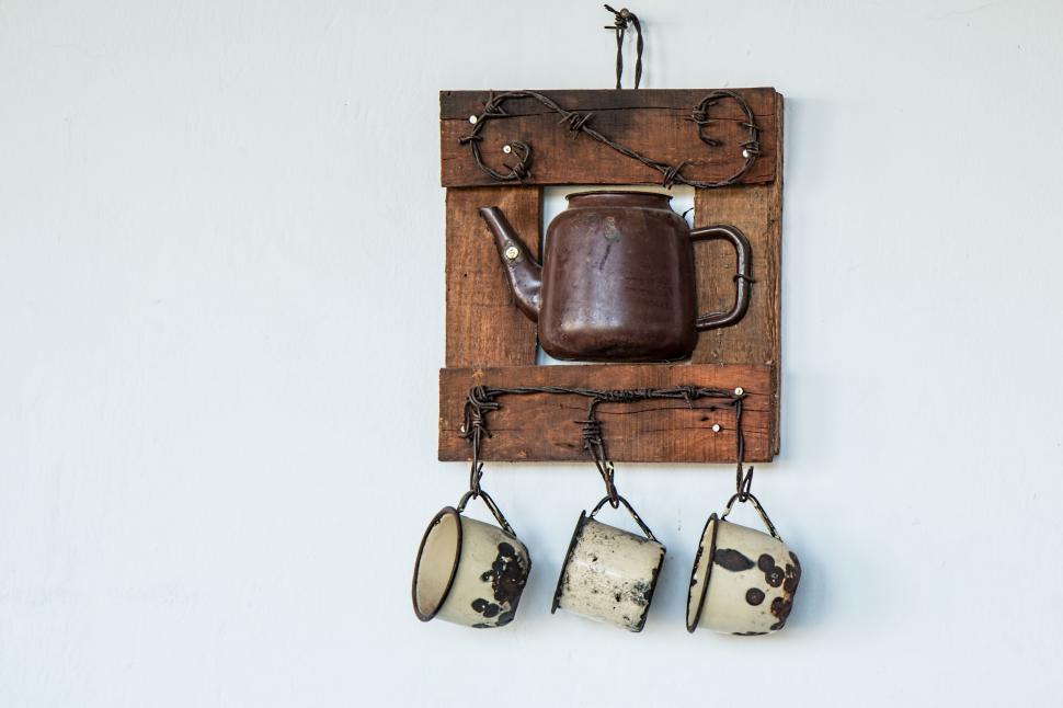 Free Image of Tea Pot and Two Mugs Hanging on Wall 