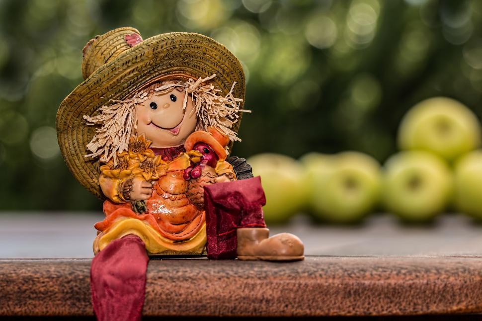 Free Image of Small Scarecrow Doll Sitting on Table 