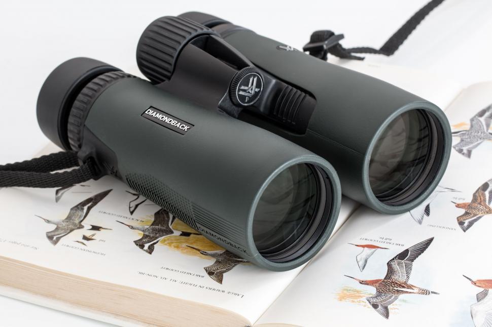Free Image of Binoculars on Top of a Book 