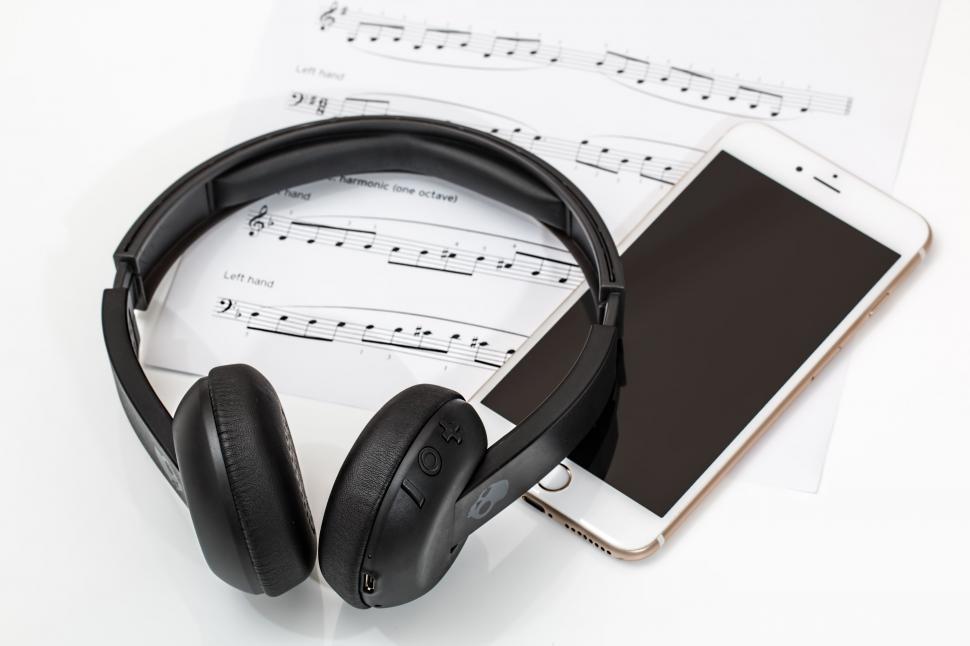 Free Image of Headphones Resting on Top of Music Sheets 