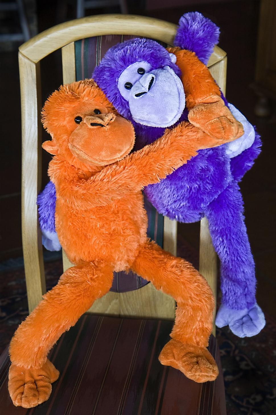 Free Image of monkey fluffy toy ape cuddly soft furry stuffed happy cute play hug cheerful smiling fun together embracing companion togetherness embrace friends friendship pal chum mate hugging buddies 
