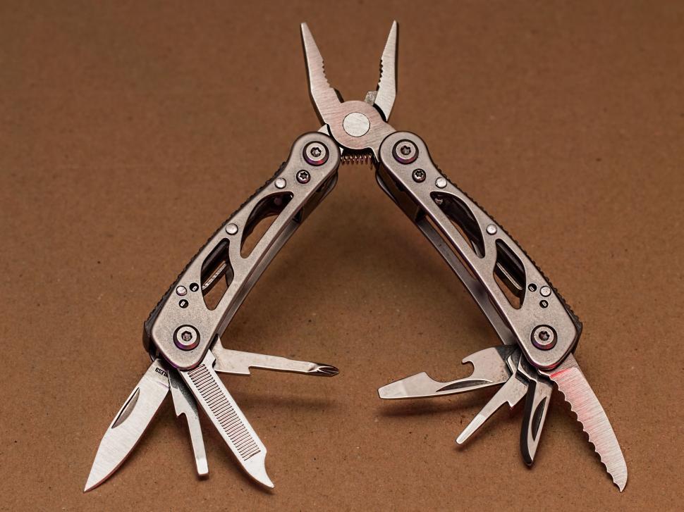 Free Image of Pair of Multi-Tool Scissors on Brown Surface 