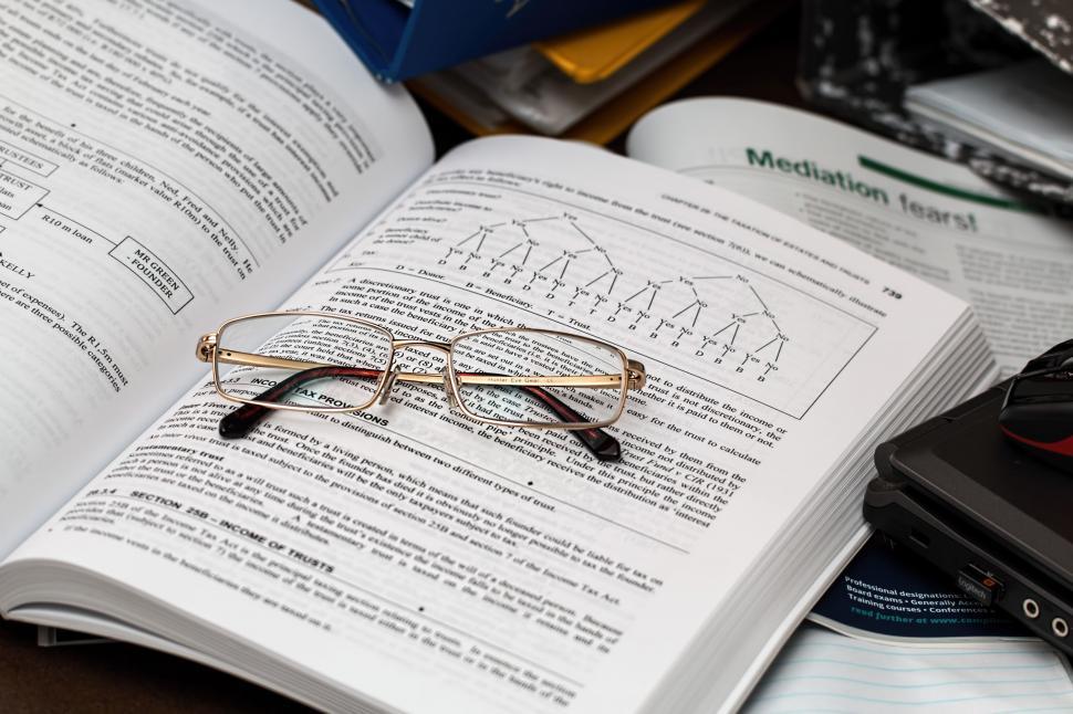 Free Image of tax paperwork accounting business finance budget economy taxation financial accountant open book spectacles irs taxpayer specs glasses reference book law book learn study student knowledge swot read 