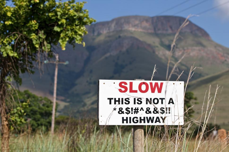 Free Image of SLOW This Is Not a Highway - Warning Signboard  