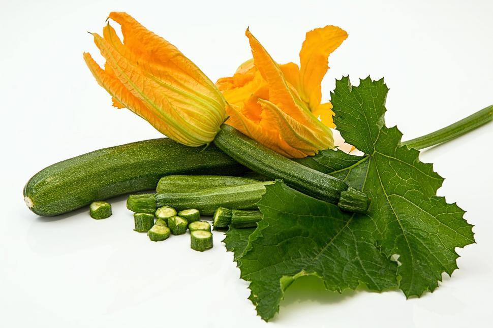 Free Image of Cucumber and Leaves on White Surface 