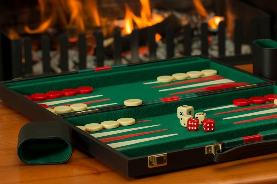 Free Image of backgammon board game fireside competition challenge dice leisure play luck game recreation red green winner gaming entertainment casino gamble win chance gambling fortune risk winter log fire warm warmth hearth 