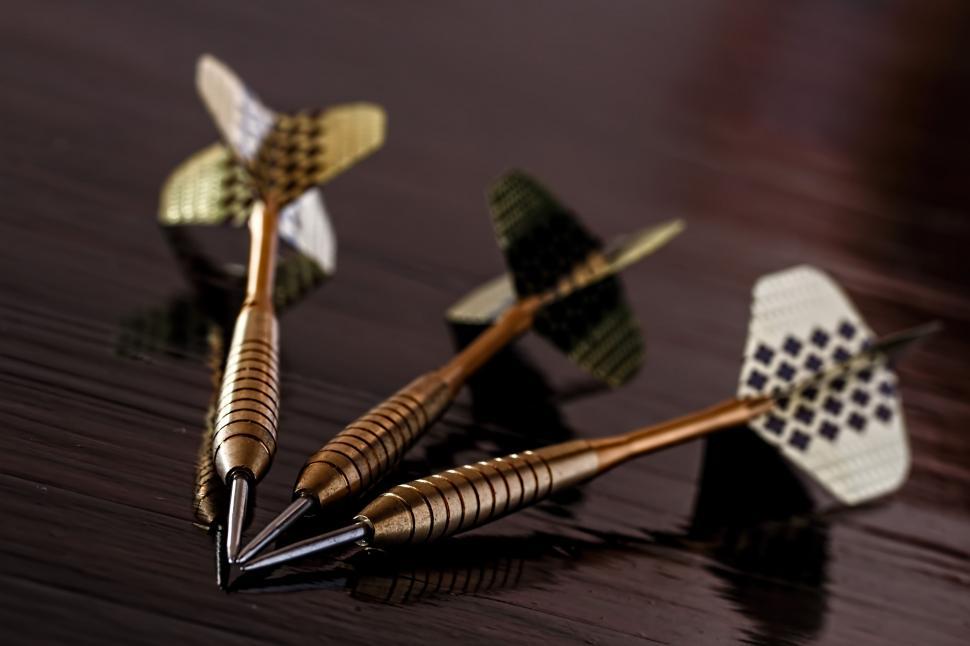 Free Image of Three Metal Darts on Wooden Table 