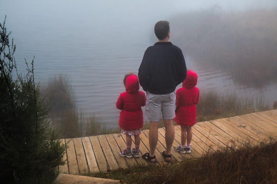 Free Image of Man and Two Children Standing on Dock 