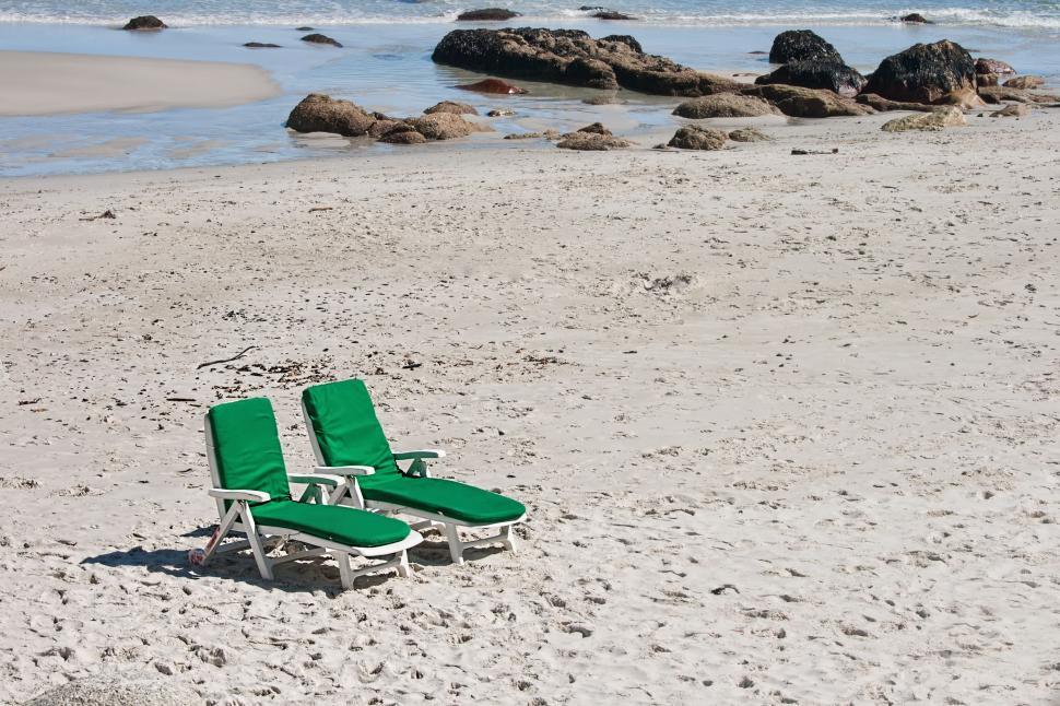 Free Image of Lawn Chairs on Sandy Beach 