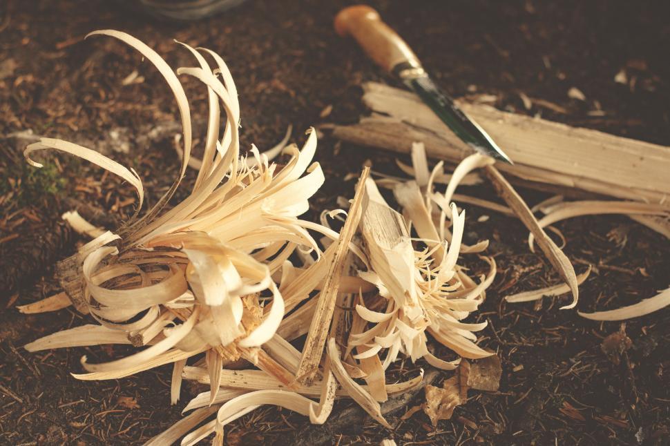 Free Image of Piles of Wood Shavings on the Ground 