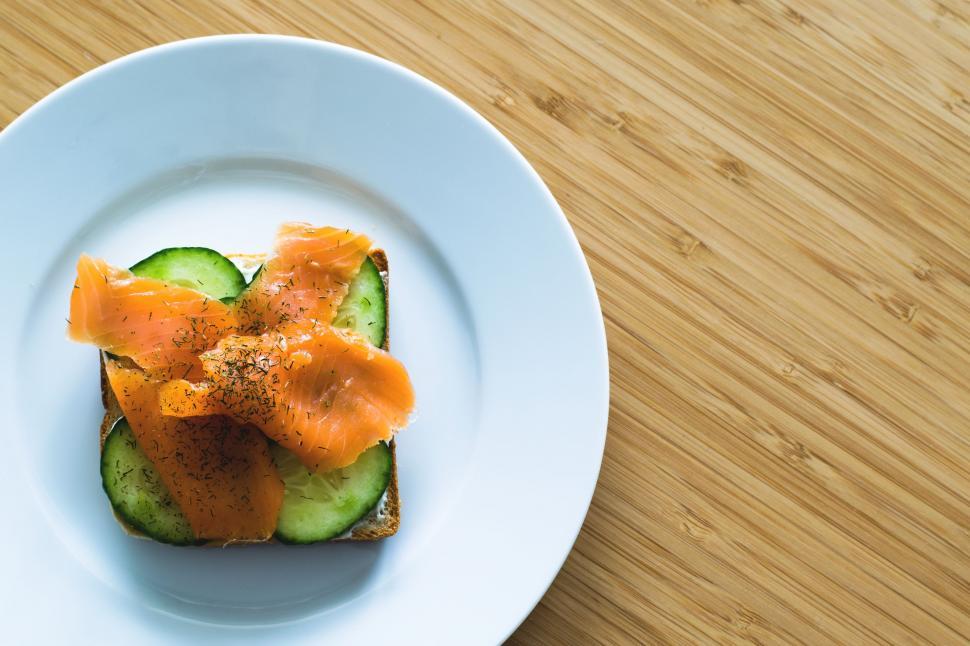 Free Image of Overhead view of Open Salmon Sandwich on white plate  