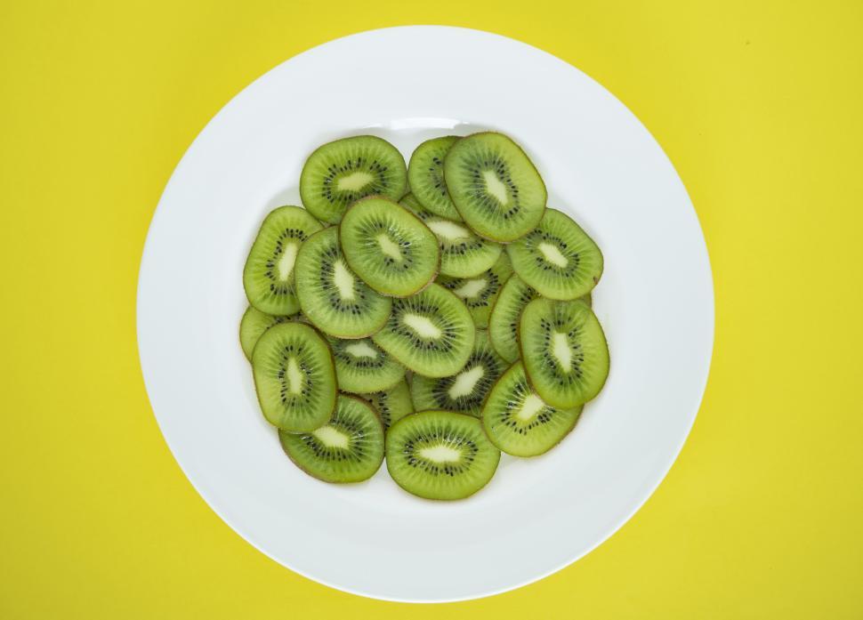 Free Image of Flat lay of kiwi slices on white plate 