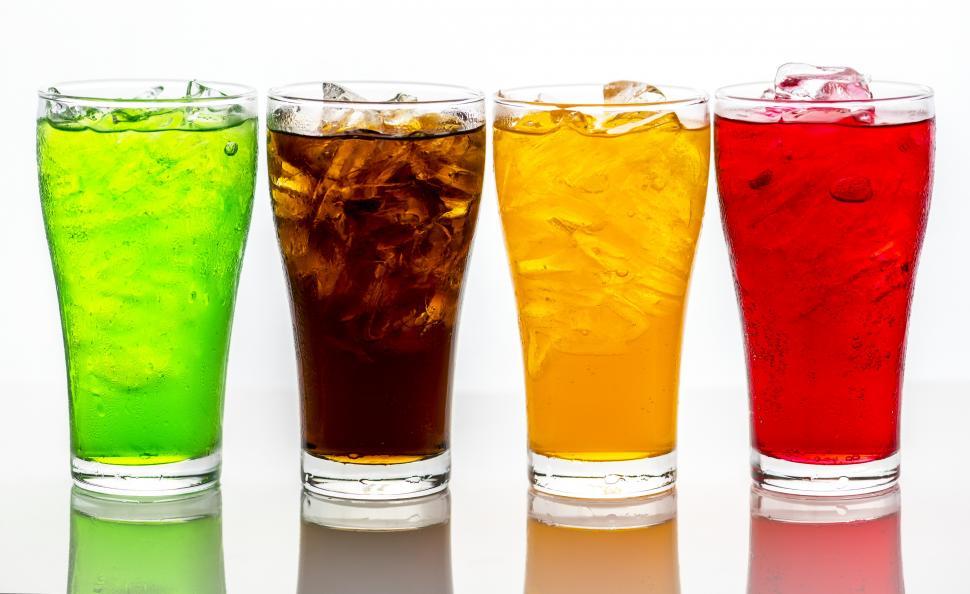 Free Image of Colorful line-up of soft drinks in pint glasses 
