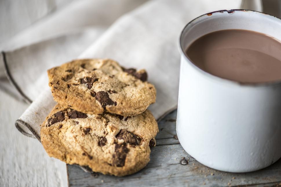 Free Image of Close up of chocolate chip cookies and hot chocolate in a mug 
