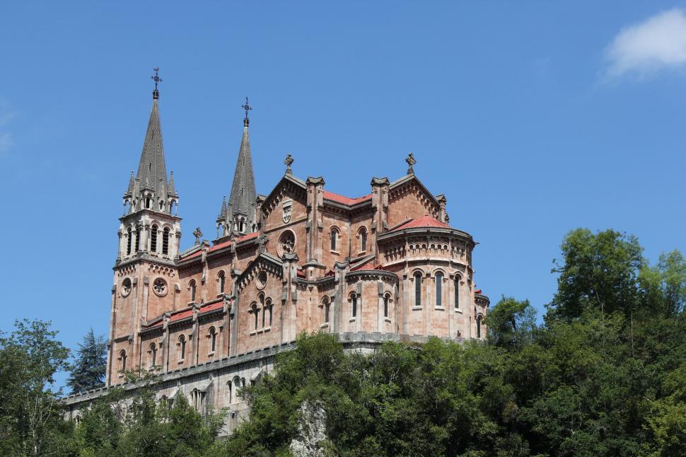 Free Image of Church Covadonga with blue sky and trees  