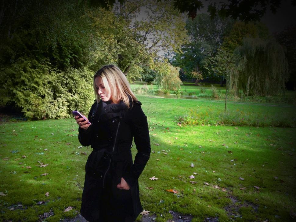 Free Image of Blonde Woman With iPhone in Park  