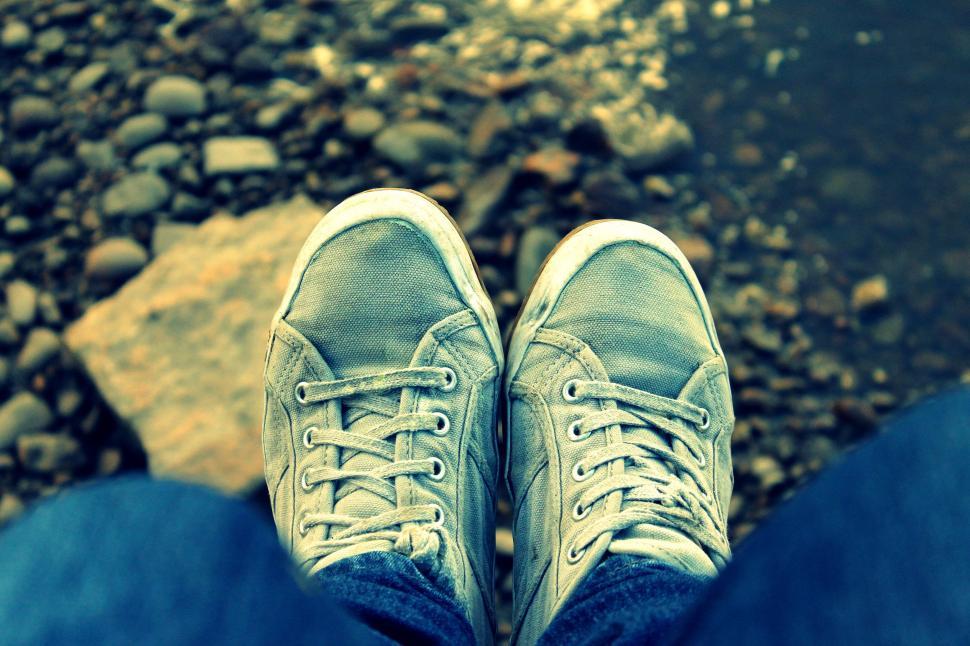 Free Image of Young man feet in grey sneakers  